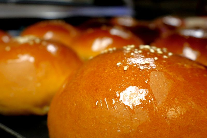 Fresh glossy buns cooling at Zimo Bakery & Cafe in Tampa